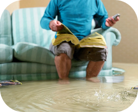 Child playing with water on a floor indoors.