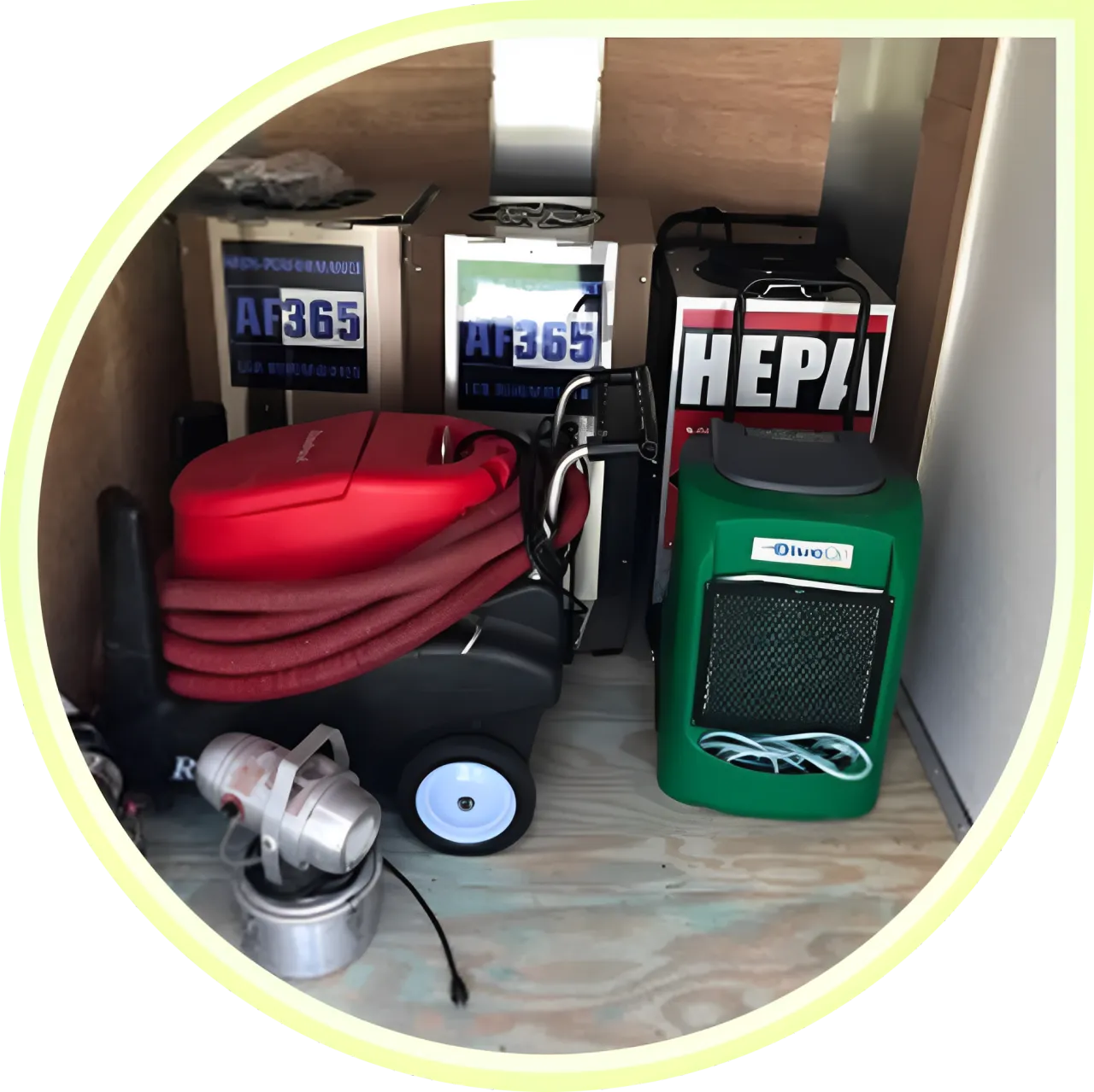 Cleaning equipment neatly organized in storage space.